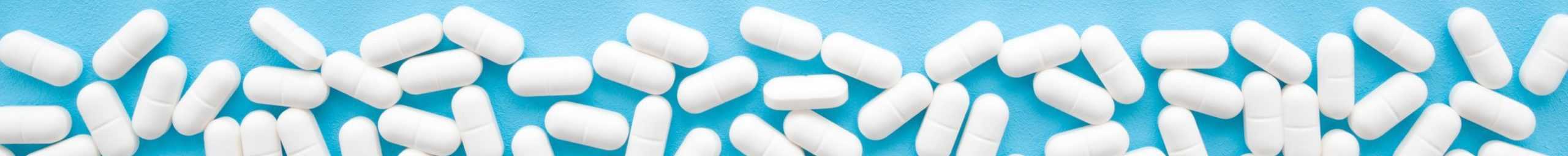 white benzodiazepine pills on a blue background