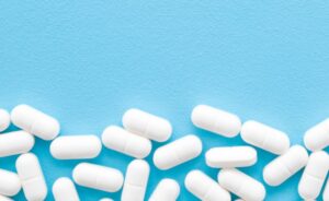 white benzodiazepine pills on a blue background