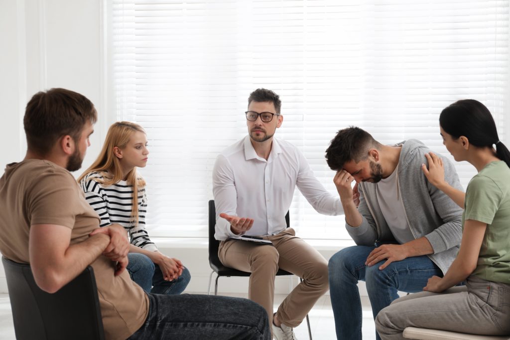 professional interventionist meets with concerned loved ones and alcoholic