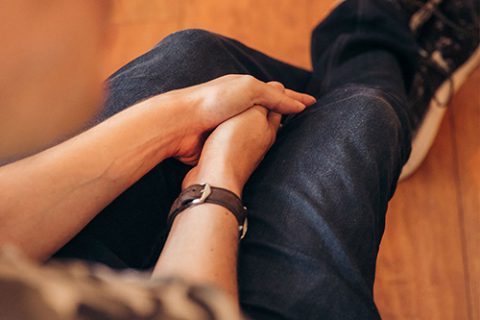 man holding his hands in his legs