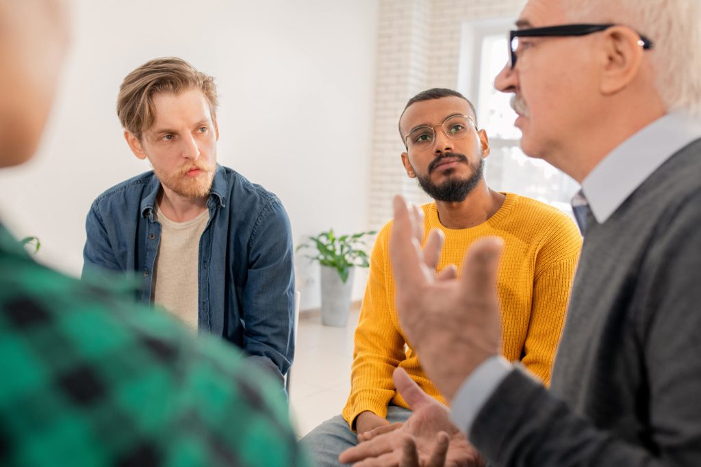 men in addiction treatment have a group therapy session