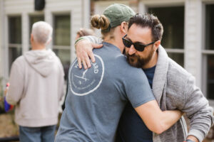 photo of two men hugging it out